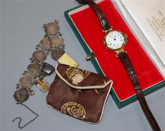 A gentlemans early 20th century 15ct gold manual wind wrist watch and a coin bracelet.